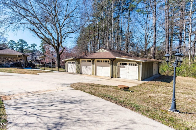 detached garage featuring fence