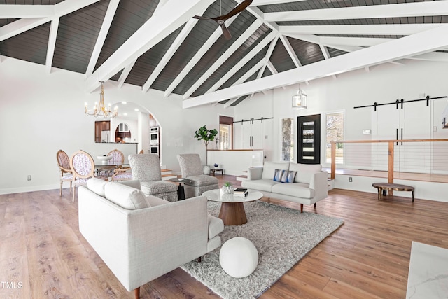 living room with high vaulted ceiling, a chandelier, wood finished floors, and beamed ceiling