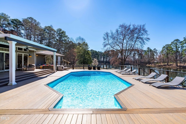 view of swimming pool featuring a fenced in pool, a patio area, and a wooden deck