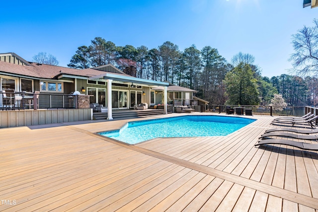 view of swimming pool featuring a deck and a fenced in pool