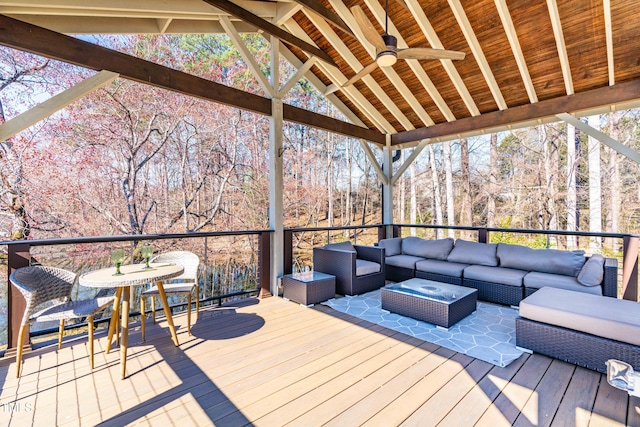 wooden terrace featuring outdoor lounge area and a ceiling fan