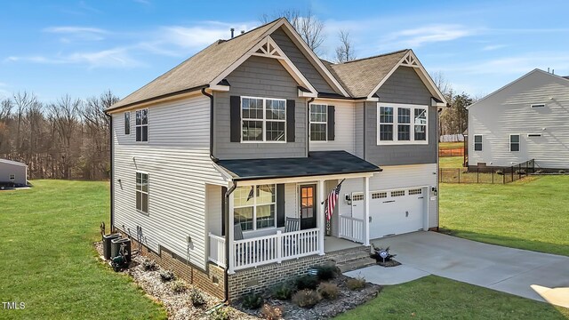 1318 Reading Ct, Burlington, NC 27217 - view of front of house with a front lawn, driveway, a porch, a garage, and a shingled roof
