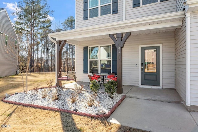 view of exterior entry featuring a porch