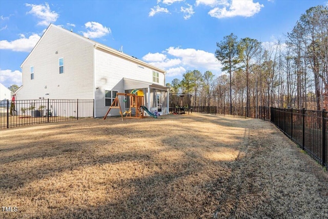 back of property with a yard, a playground, a fenced backyard, and central air condition unit