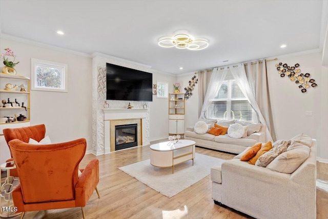 living room featuring ornamental molding, wood finished floors, and a wealth of natural light