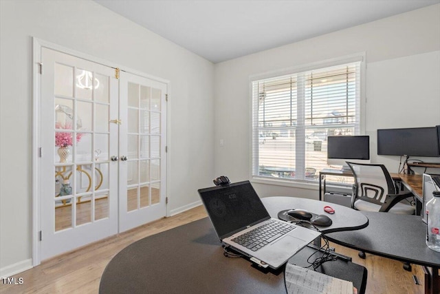 home office featuring baseboards, wood finished floors, and french doors