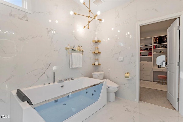 bathroom with marble finish floor, visible vents, toilet, a jetted tub, and stone wall