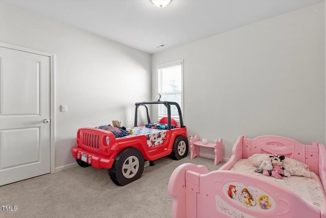 bedroom with carpet floors and baseboards