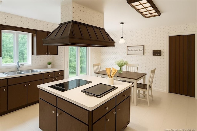 1855 Riverside Blvd, Lumberton, NC 28358 - kitchen featuring black electric cooktop, wallpapered walls, a sink, premium range hood, and light countertops