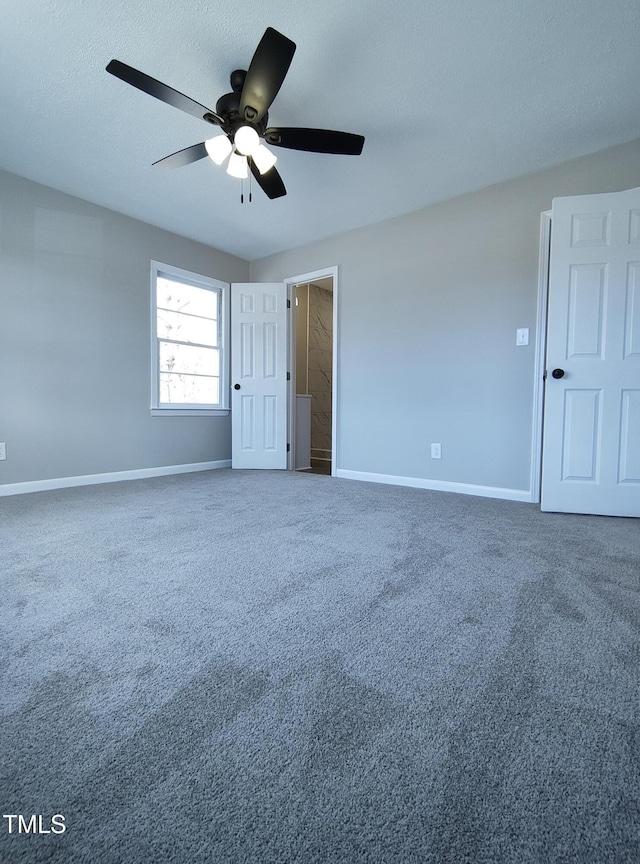 unfurnished bedroom featuring carpet flooring, ceiling fan, a textured ceiling, and baseboards