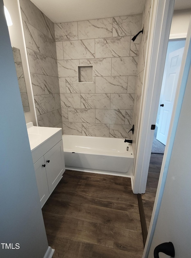 bathroom with shower / washtub combination, vanity, and wood finished floors