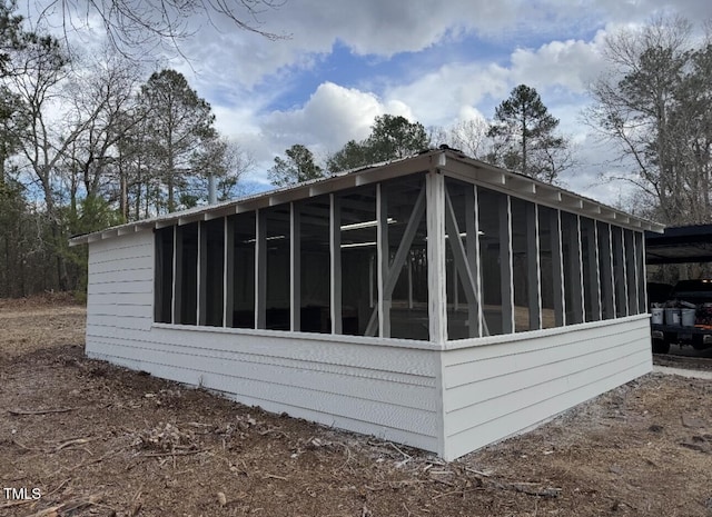 view of home's exterior with a sunroom