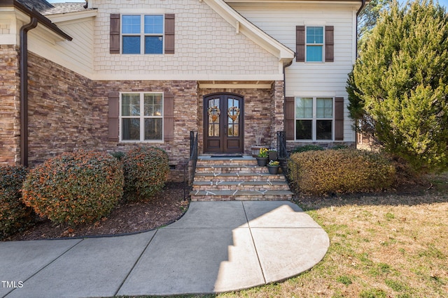 doorway to property featuring french doors and stone siding