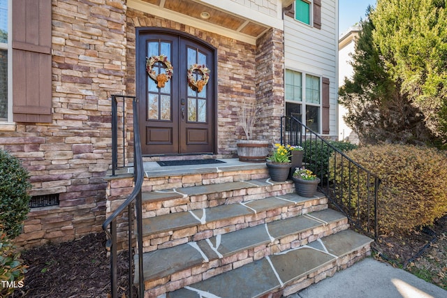 entrance to property with french doors and stone siding