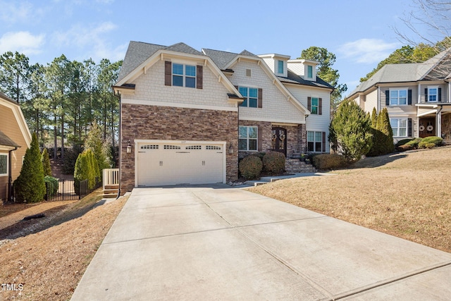 view of front of property featuring a front lawn, driveway, an attached garage, and fence