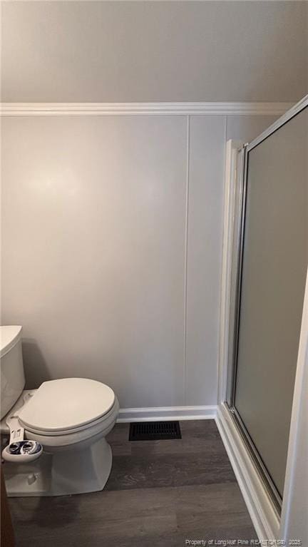 1809 Wayne Ln, Fayetteville, NC 28304 - bathroom with visible vents, a shower stall, toilet, and wood finished floors
