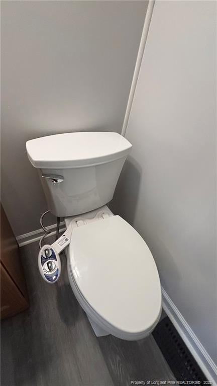 1809 Wayne Ln, Fayetteville, NC 28304 - bathroom featuring baseboards, toilet, and wood finished floors