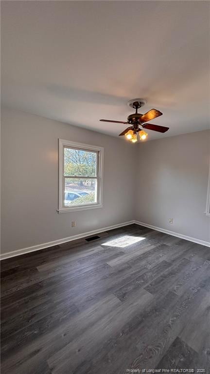 1809 Wayne Ln, Fayetteville, NC 28304 - empty room featuring dark wood-style floors, visible vents, baseboards, and a ceiling fan