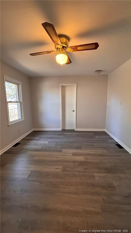 1809 Wayne Ln, Fayetteville, NC 28304 - empty room with dark wood-style floors, visible vents, baseboards, and ceiling fan