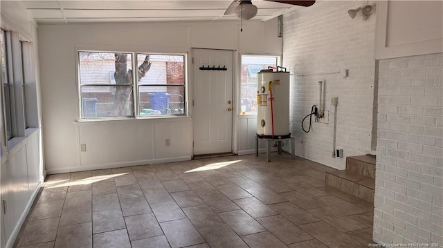 1809 Wayne Ln, Fayetteville, NC 28304 - foyer entrance featuring brick wall, water heater, baseboards, and a ceiling fan