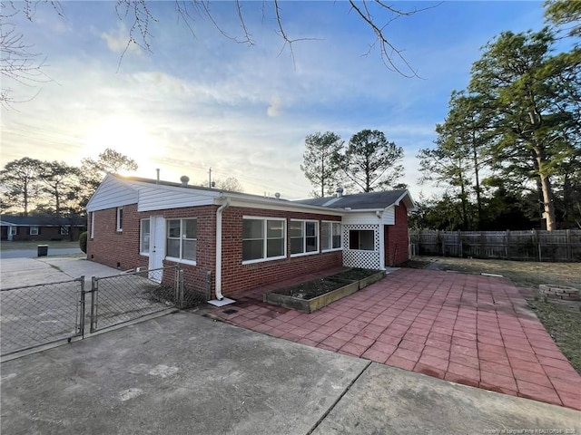 1809 Wayne Ln, Fayetteville, NC 28304 - view of front of property featuring a patio area, a gate, brick siding, and fence