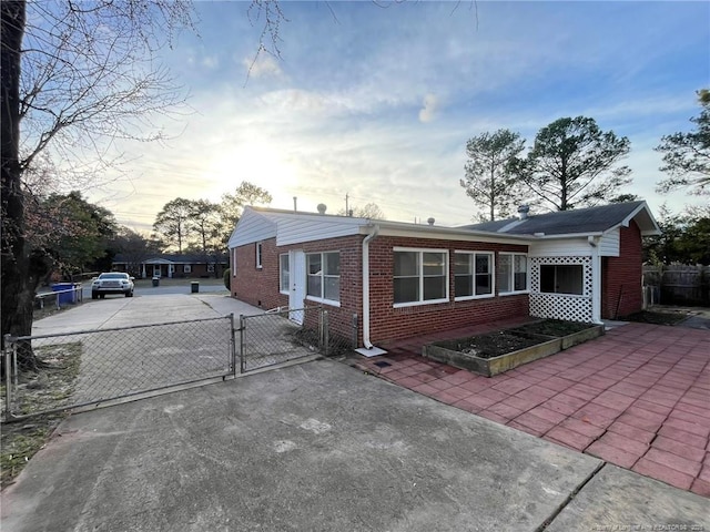 1809 Wayne Ln, Fayetteville, NC 28304 - view of front of property featuring a gate, brick siding, fence, and driveway