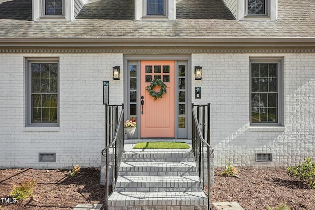 property entrance featuring crawl space and roof with shingles