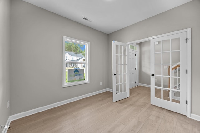 432 E Clydes Point Way, Wendell, NC 27591 - unfurnished room featuring french doors and light wood finished floors