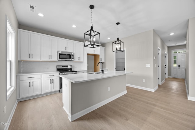 432 E Clydes Point Way, Wendell, NC 27591 - kitchen featuring stainless steel appliances, light wood-style floors, a center island with sink, white cabinets, and recessed lighting