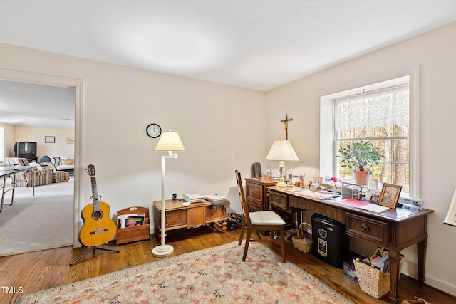 office featuring baseboards and wood finished floors