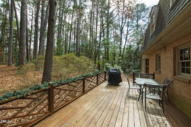 wooden terrace with a grill