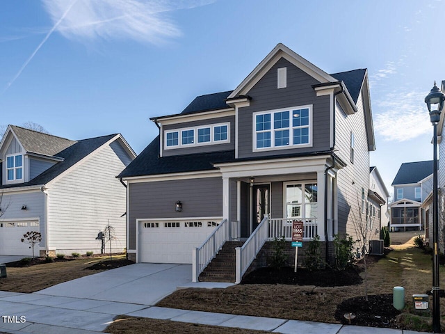 view of front of home with covered porch, driveway, an attached garage, and central air condition unit