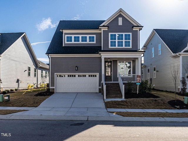 view of front facade featuring a garage, covered porch, and concrete driveway