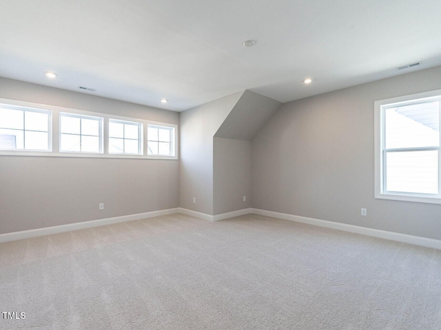 bonus room featuring light carpet, recessed lighting, visible vents, and baseboards