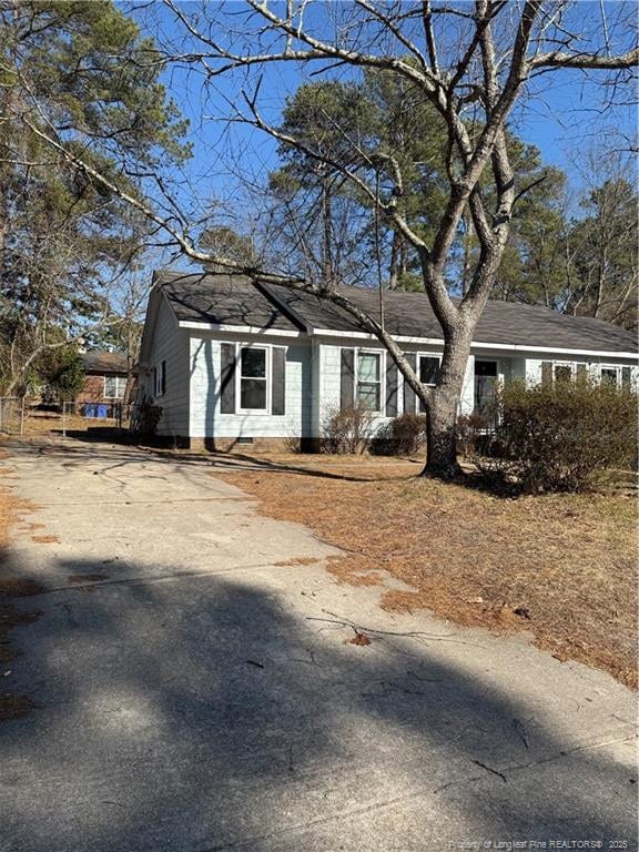 view of front of property with driveway and crawl space