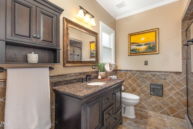 bathroom with crown molding, tile walls, visible vents, toilet, and vanity