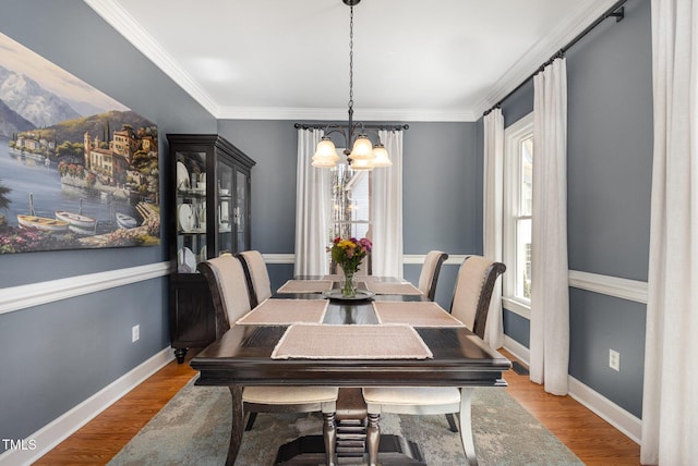 dining space featuring plenty of natural light, baseboards, and wood finished floors