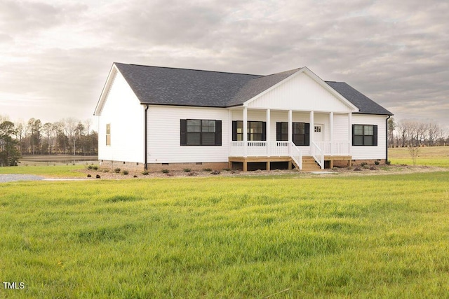 rear view of house with a yard, a shingled roof, crawl space, and a porch