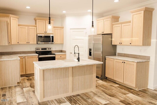 kitchen with light brown cabinets, appliances with stainless steel finishes, and ornamental molding