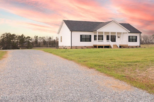 view of front of house with driveway, roof with shingles, crawl space, covered porch, and a front lawn