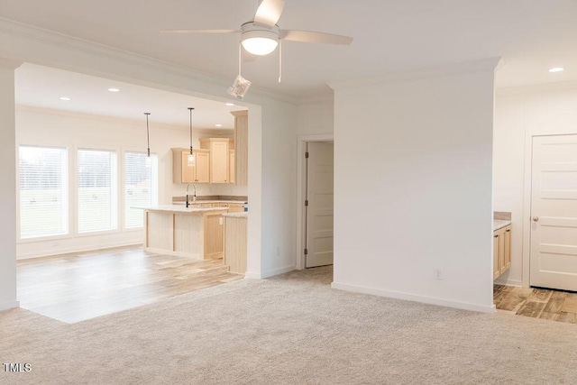 unfurnished living room with baseboards, light colored carpet, ceiling fan, crown molding, and recessed lighting