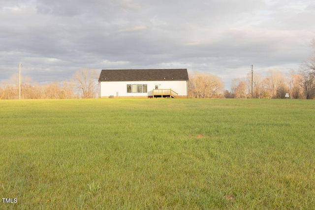 view of front of home with a rural view and a front yard