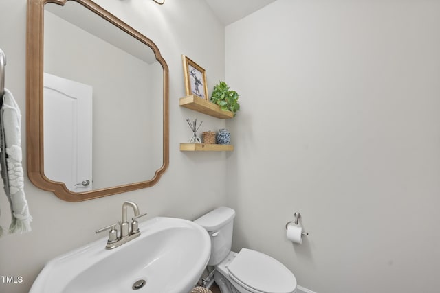 half bathroom with a sink and toilet