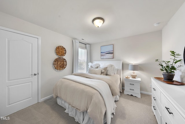 bedroom featuring baseboards and light colored carpet