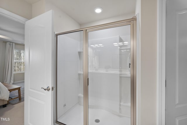 bathroom featuring a stall shower and ensuite bath