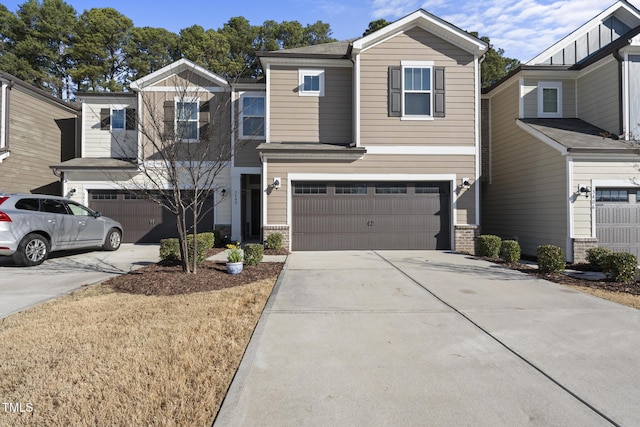 view of front of property featuring a garage and concrete driveway