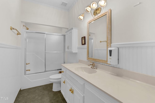 full bathroom with visible vents, toilet, wainscoting, vanity, and tile patterned flooring