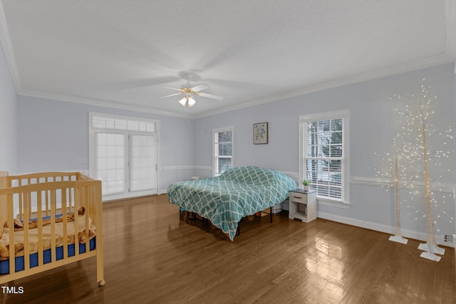 bedroom with ornamental molding, wood finished floors, and a ceiling fan