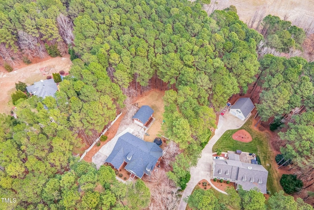 birds eye view of property featuring a view of trees