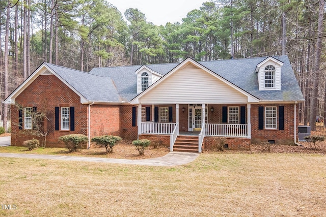 view of front of property featuring a front lawn, crawl space, brick siding, and covered porch